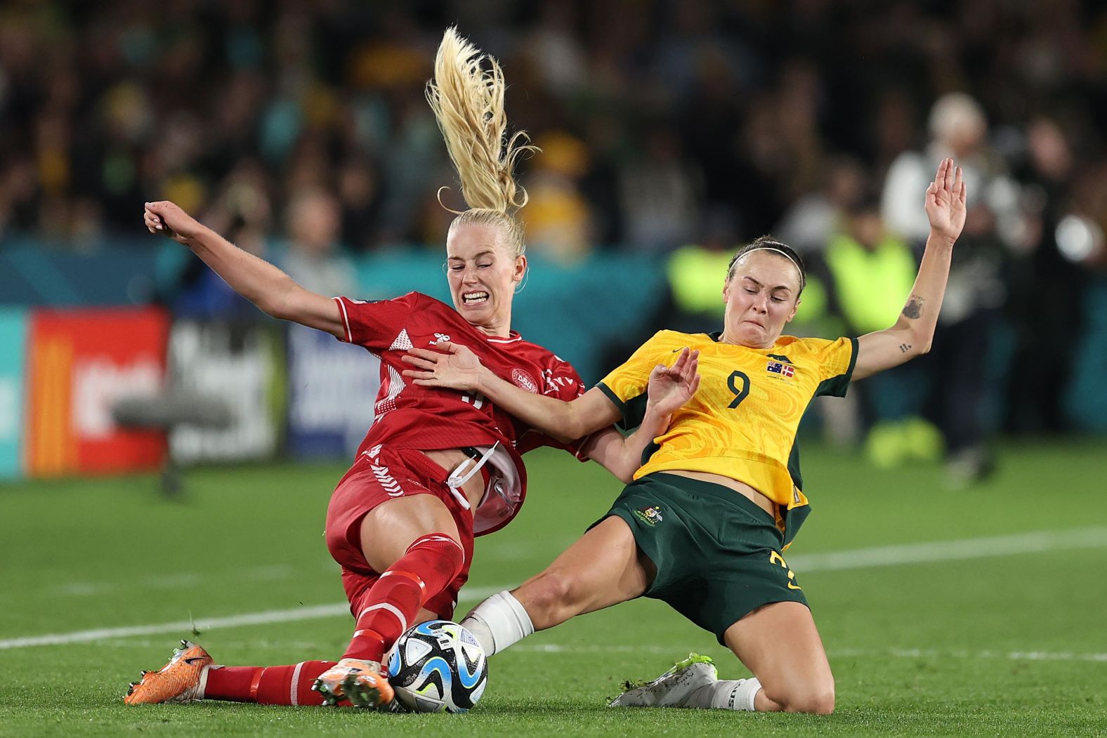 Denmark's Amalie Vangsgaard, left, and Australia's Caitlin Foord compete for the ball during a round-of-16 match on August 7. <a href="https://edition.cnn.com/sport/live-news/england-nigeria-australia-denmark-womens-world-cup-knockout/h_96eb0aafc77d71f7b18c062bbe444f8a" target="_blank">Australia won 2-0</a> to advance to the quarterfinals.