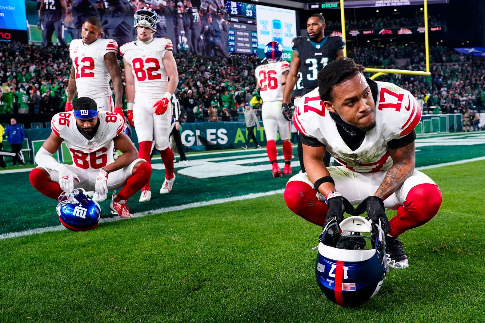 New York Giants wide receiver Wan'Dale Robinson, right, and teammates react to their 33-25 loss to the Philadelphia Eagles on Monday, December 25.