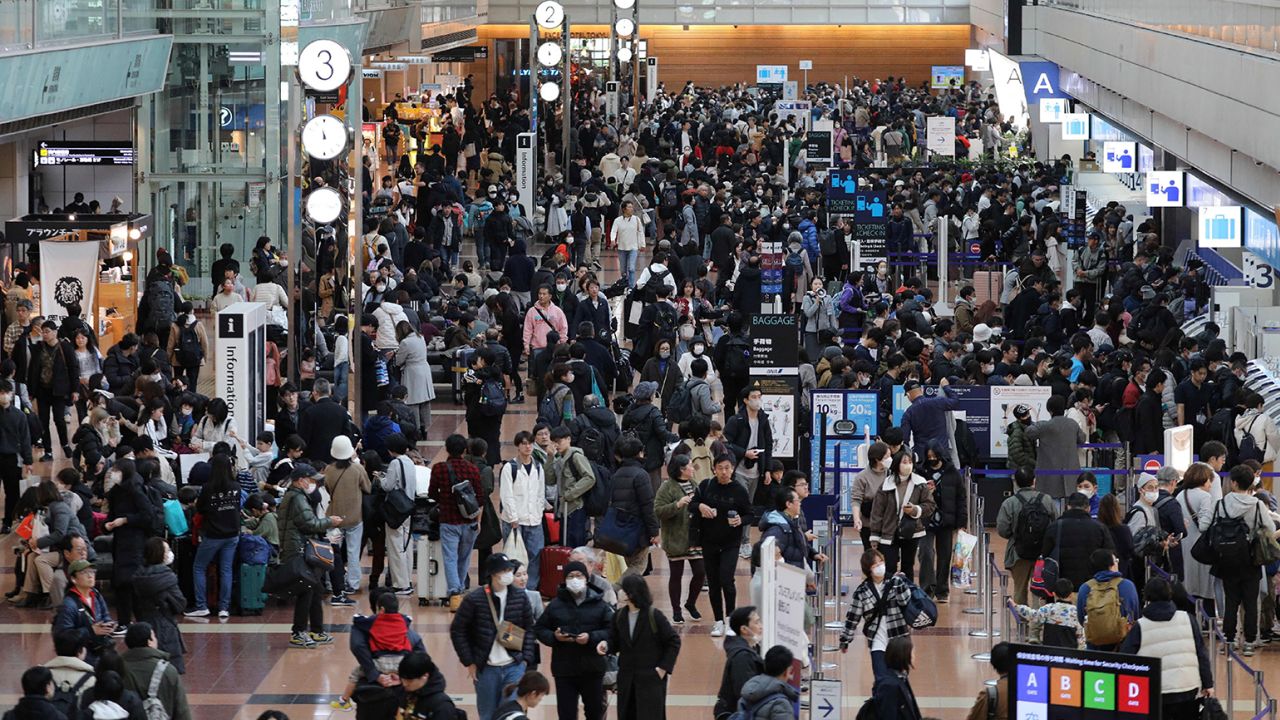 Travelers crowd the check-in area at terminal 2 at Tokyo International Airport at Haneda on January 3, 2024, as flight delays on one of the busiest travel days of the year following the New Year's Day holidays were made worse due to the collision on the tarmac the night before between a coast guard plane and a Japan Airlines (JAL) passenger jet, shutting down one of the main runways.