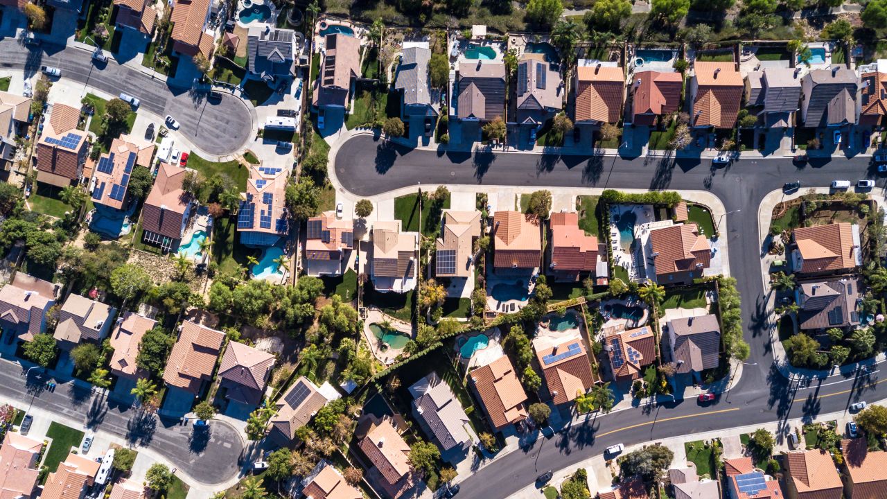 Top down aerial shot of suburban tract housing near Santa Clarita, California. A maze of roads and dead end streets of large single family homes, some with swimming pool.