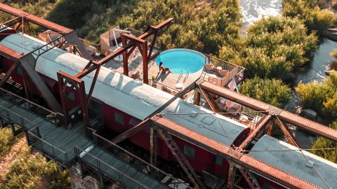 A visitor sits in the swimming pool at Kruger Shalati: The Train on the Bridge in Kruger National Park, South Africa.