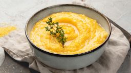 Corn polenta on gray background. Healthy food concept.