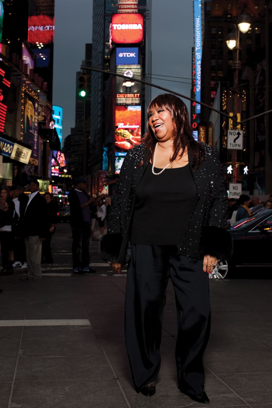 Franklin reacts to a NYPD officer asking for her autograph while she was being photographed in Times Square in June 2009. 