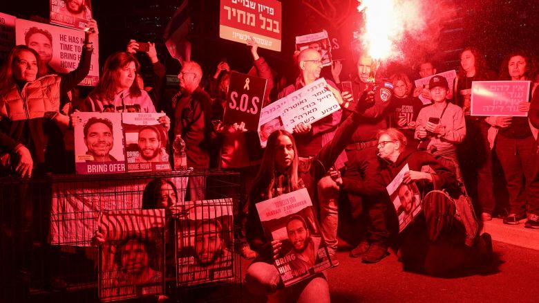 TOPSHOT - Relatives and supporters of Israeli hostages held in Gaza since the October 7 attacks by Hamas militants, hold placards during a demonstration in Tel Aviv, on March 26, 2024, amid the ongoing conflict in the Gaza Strip between Israel and the Palestinian militant Hamas movement. (Photo by JACK GUEZ / AFP) (Photo by JACK GUEZ/AFP via Getty Images)