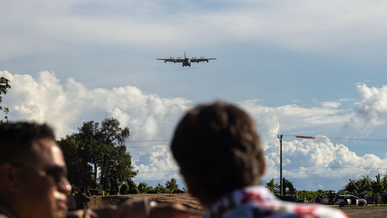 U.S. Marines and Sailors with Marine Corps Engineer Detachment Palau 24.1, and locals of Peleliu, observe a U.S. Marine Corps KC-130J Super Hercules aircraft with 1st Marine Air Wing, land on a newly designated airstrip on the island of Peleliu, Republic of Palau, June 22, 2024. For the first time since its recertification in June, a military fixed-wing aircraft has touched down on the historic Peleliu airstrip, marking a significant and triumphant return to this iconic World War II site. (U.S. Marine Corps photo by Lance Cpl. Hannah Hollerud)