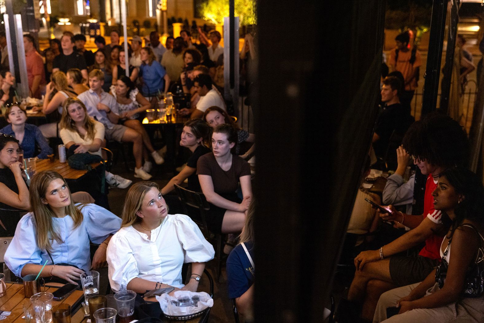 Patrons watch the CNN presidential debate during a watch party at Union Pub in Washington, DC on June 27, 2024. The debate, held in Atlanta, Georgia, marks the first in-person showdown between President Joe Biden and former President Donald Trump of the 2024 election cycle.