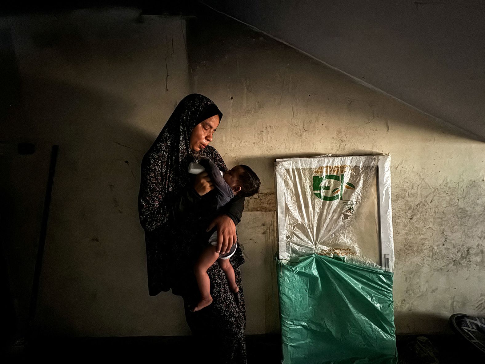 A displaced Palestinian woman feeds her son milk at a shelter in Khan Younis, Gaza, on Wednesday, June 26. A report published Tuesday by the Integrated Food Security Phase Classification, which assesses global food insecurity and malnutrition, <a href="https://www.cnn.com/2024/06/25/middleeast/israel-gaza-children-starvation-malnutrition-intl/index.html">warned that almost all of Gaza will face famine within the next three months</a>.