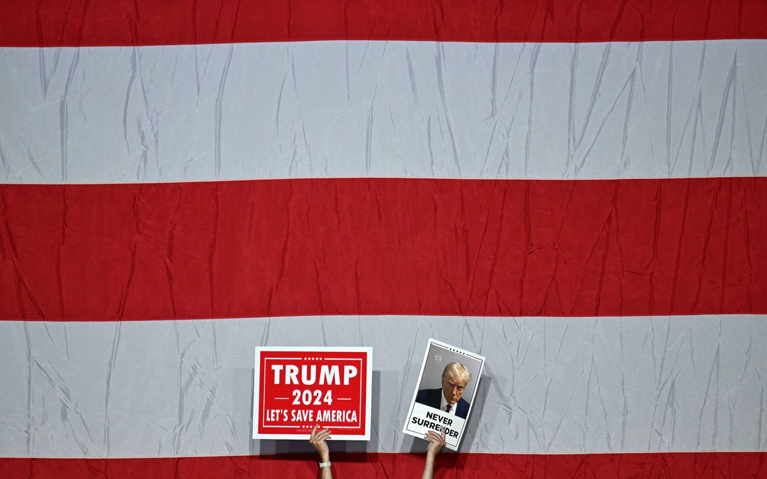 Supporters of former US President Donald Trump hold up placards as they wait for him to speak at a rally in Philadelphia on Saturday, June 22.