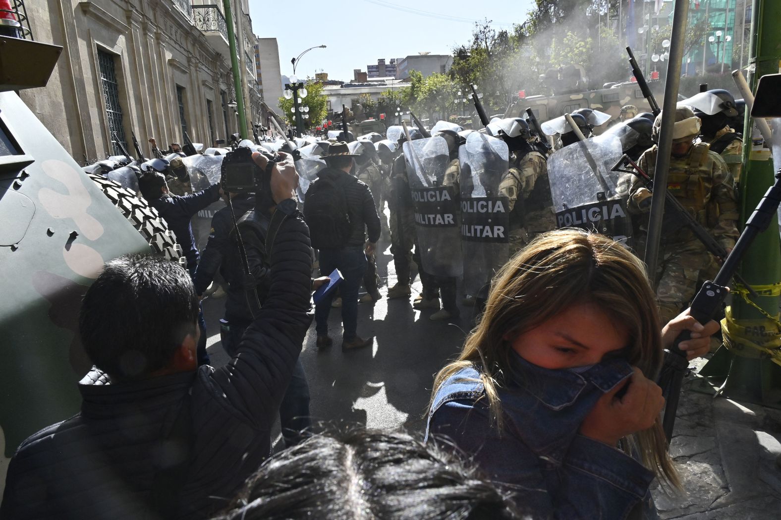 A woman walks away from tear gas fired by military troops in La Paz, Bolivia, on Wednesday, June 25. <a href="https://www.cnn.com/2024/06/26/americas/bolivia-coup-attempt-claims-intl-latam/index.html">A Bolivian general was arrested and accused of mounting a coup against the government</a> after attempting to storm the presidential palace on Wednesday.