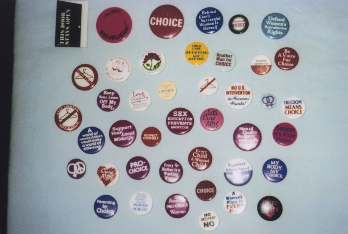 Advocacy pins are displayed in another photo from the Emma Goldman Clinic archive, held by the Iowa Women’s Archive at the University of Iowa.