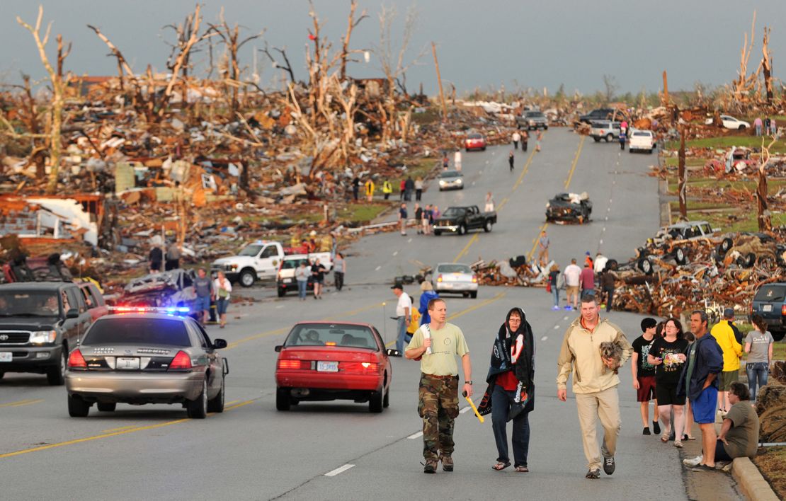 Residents walk in the street after a massive tornado hit Joplin, Missouri, on May 22, 2011.