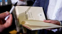 JD Vance, the venture capitalist and author of "Hillbilly Elegy," autographs a book after a rally Thursday, July 1, 2021, in Middletown, Ohio, where he announced he is joining the crowded Republican race for the Ohio U.S. Senate seat being left by Rob Portman. (AP Photo/Jeff Dean)