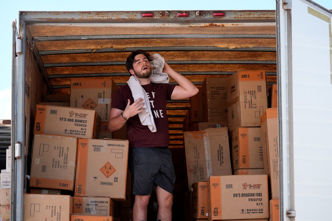 Ethan Hickman takes a break from unloading a trailer of fireworks in Weldon Spring, Missouri, on June 17, 2024.