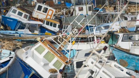 A fisherman looks at fishing vessels damaged by Hurricane Beryl at the Bridgetown Fisheries in Barbados, Monday, July 1, 2024. (AP Photo/Ricardo Mazalan)