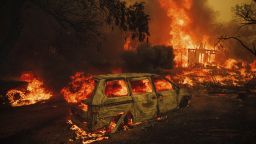 A property is engulfed in flames as the Thompson Fire burns, Tuesday, July 2, 2024, in Oroville, Calif. (AP Photo/Ethan Swope)