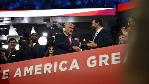 Former US President Donald Trump shakes hands with his VP nominee, JD Vance, on the first night of the Republican National Convention in Milwaukee on Monday, July 15, 2024.