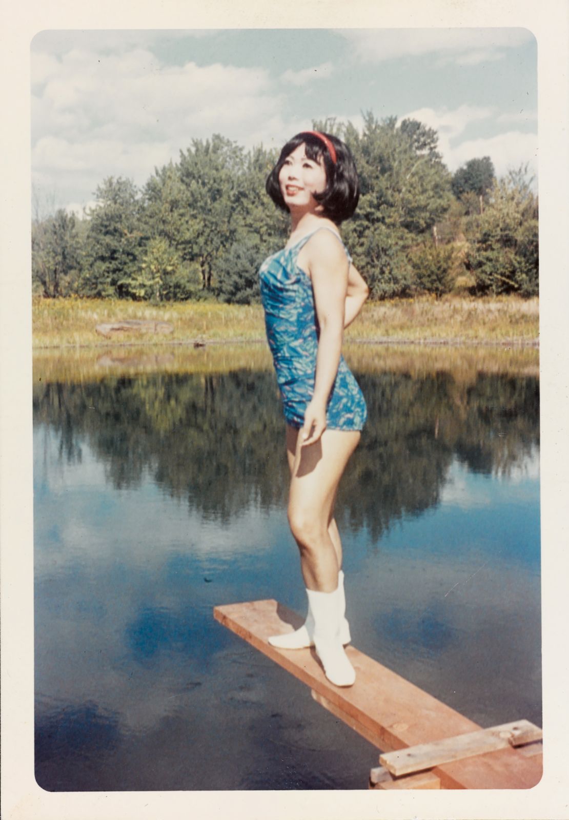 Lili, a guest at Casa Susanna, is pictured posing on a diving board at the home's outdoor pool, circa 1966.