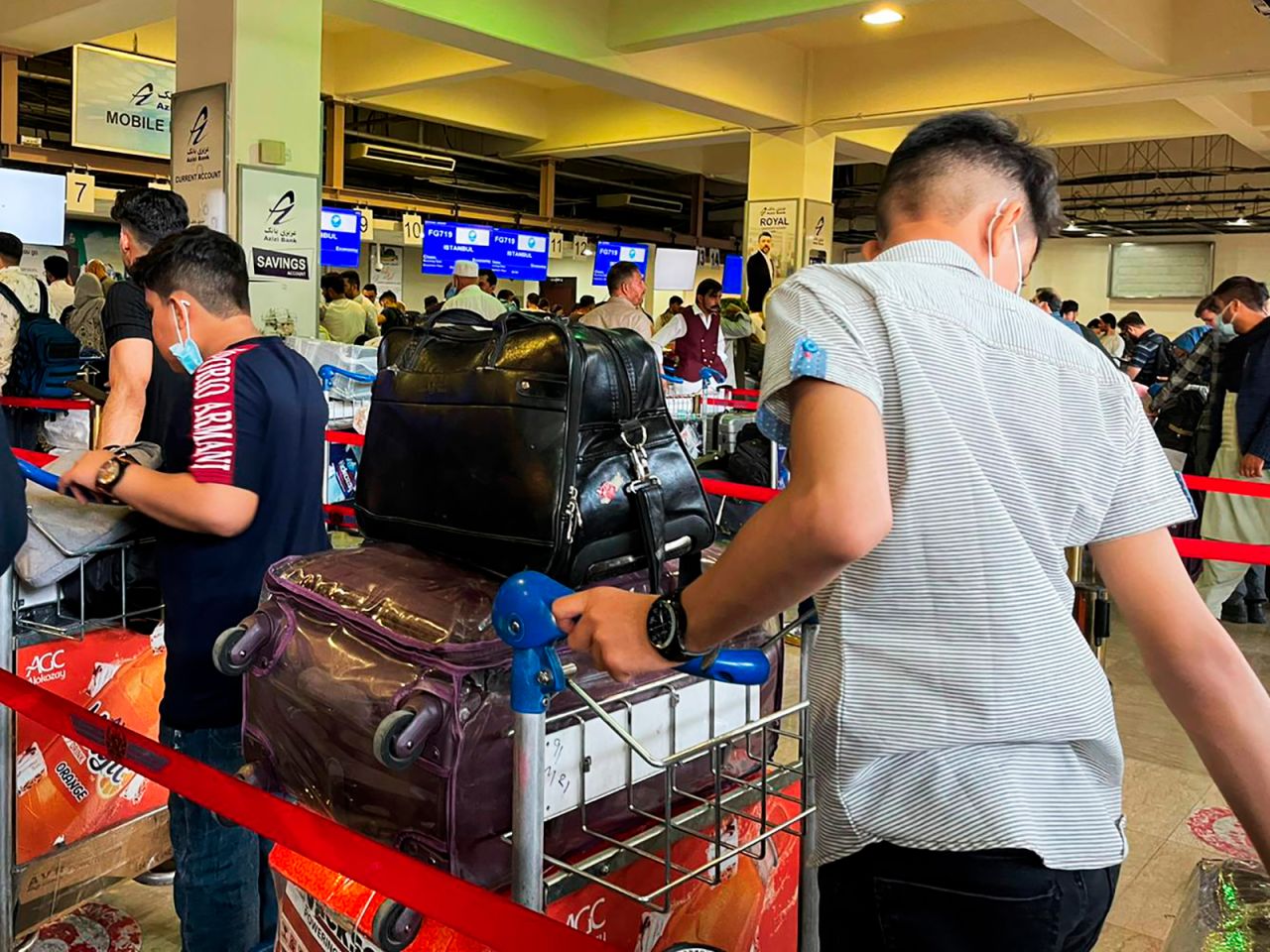 Passengers trying to fly out of Kabul International Airport amid the Taliban offensive wait in line in Kabul, Afghanistan, on August 13.