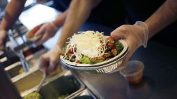 An employee prepares a burrito bowl at a Chipotle Mexican Grill Inc. restaurant in Louisville, Kentucky, U.S., on Saturday, Feb. 2, 2019.