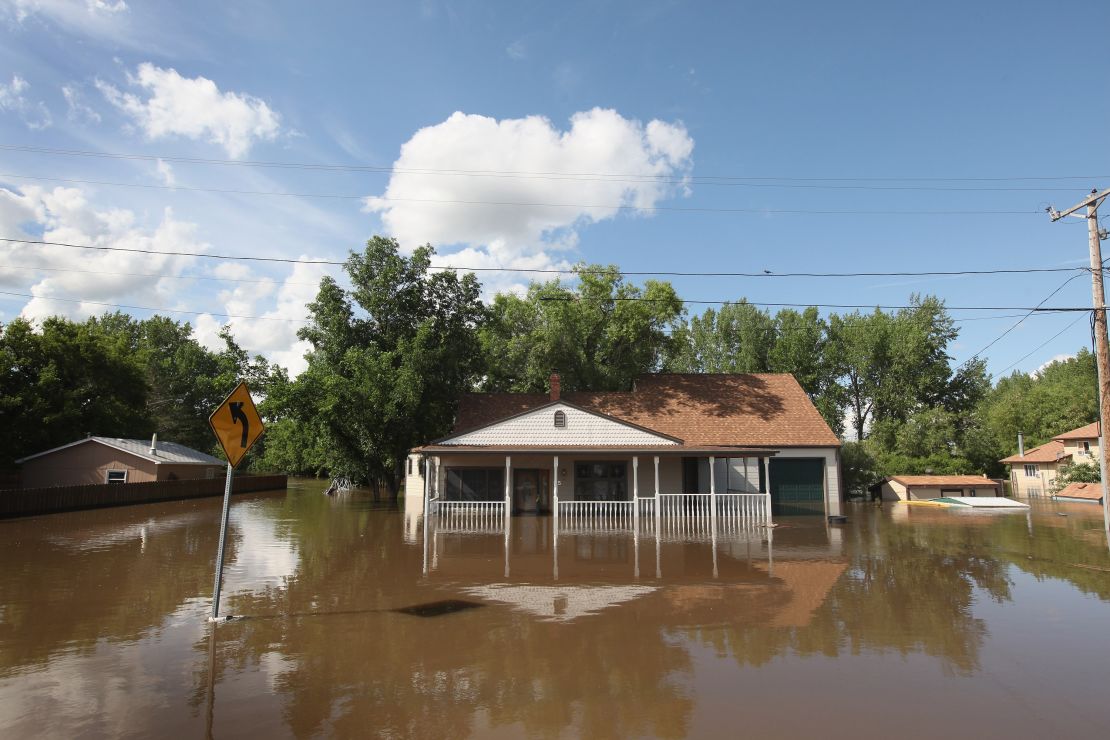 BURLINGTON, ND - JUNE 26: A home is surrounded by floodwater June 26, 2011 in Burlington, North Dakota. The Souris River, which runs through Burlington and nearby Minot, crested early this morning after flooding more than 4,000 homes in the two communities. (Photo by Scott Olson/Getty Images)