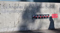 The shadow of a pedestrian is seen walking past the headquarters of the Los Angeles Unified School District on October 3, 2022 in Los Angeles, California. - LAUSD Superintendant ALberto Carvalho remains firm on Monday on his refusal to pay a ransom demanded by an international hacking syndicate, days after hacked data from the school district was posted on the dark web. A hacking syndicate known as Vice Society sent a ransom demand to the school district last week setting an October 3 deadline to pay the unspecified ransom with threats to release more hacked data online if payment is not met. (Photo by Frederic J. BROWN / AFP) (Photo by FREDERIC J. BROWN/AFP via Getty Images)