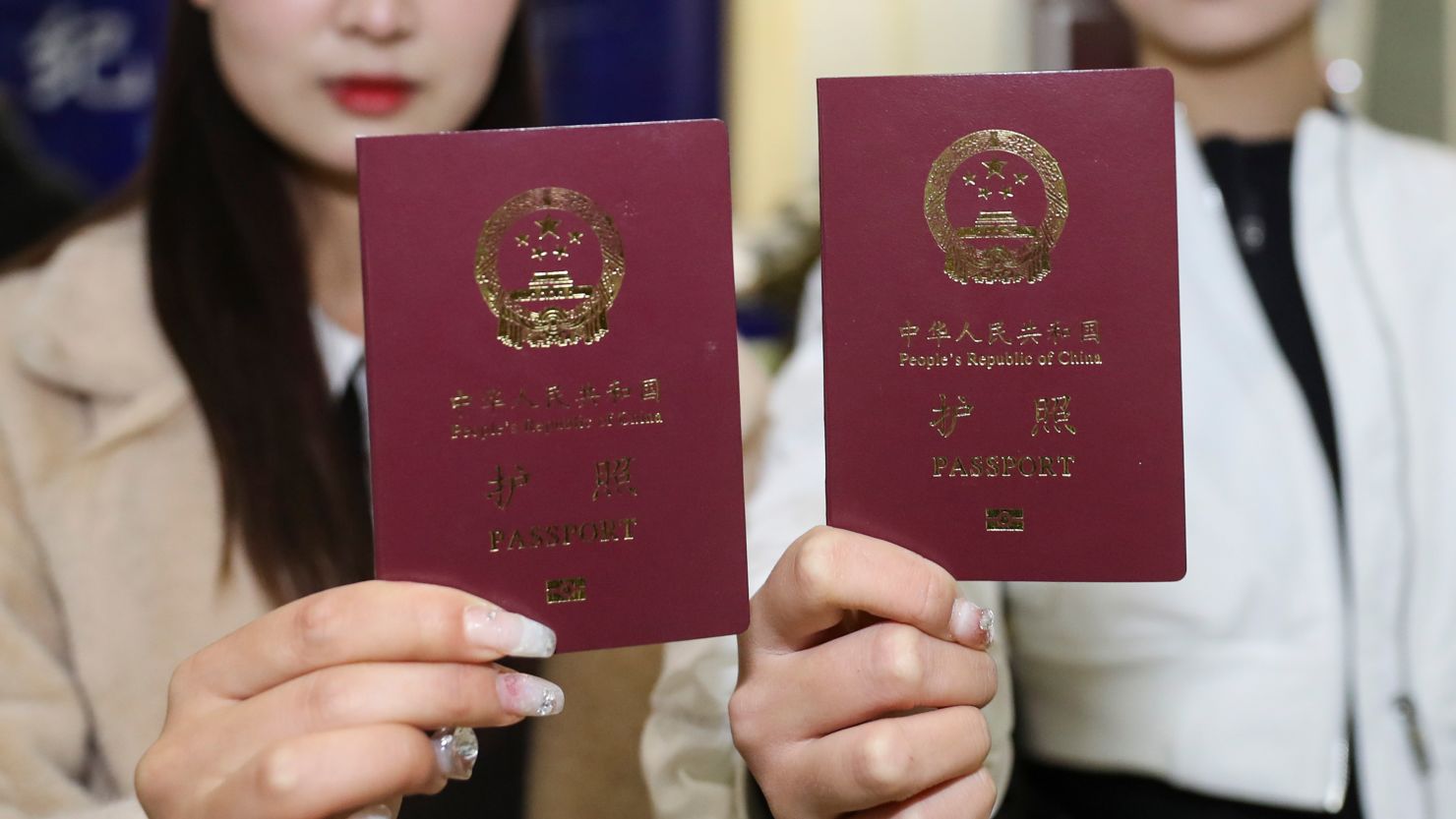 People show their passports in Huai 'an, East China's Jiangsu province in February 2023.