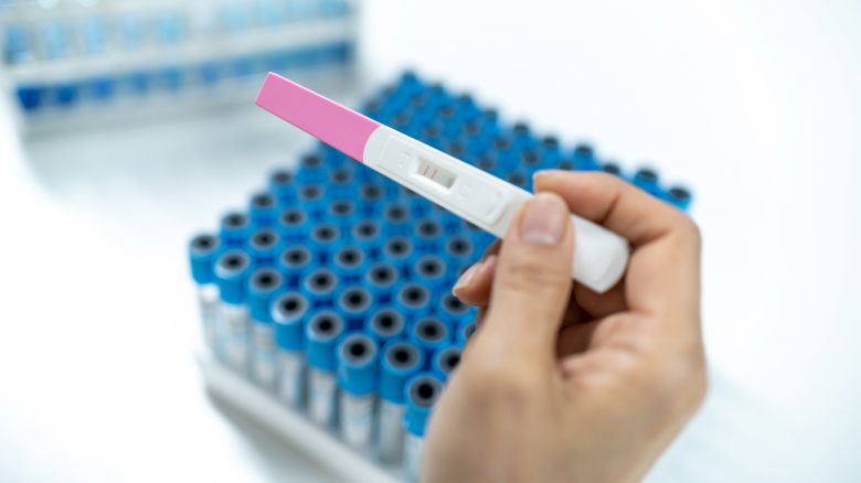 A person holds a pregnancy test.