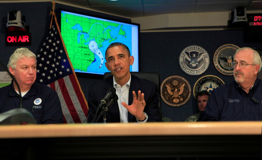 President Barack Obama makes a statement after a briefing on Hurricane Sandy with FEMA Deputy Administrator Richard Serino, left, and FEMA Administrator Craig Fugate at FEMA Headquarters on October 28, 2012, in Washington, DC.