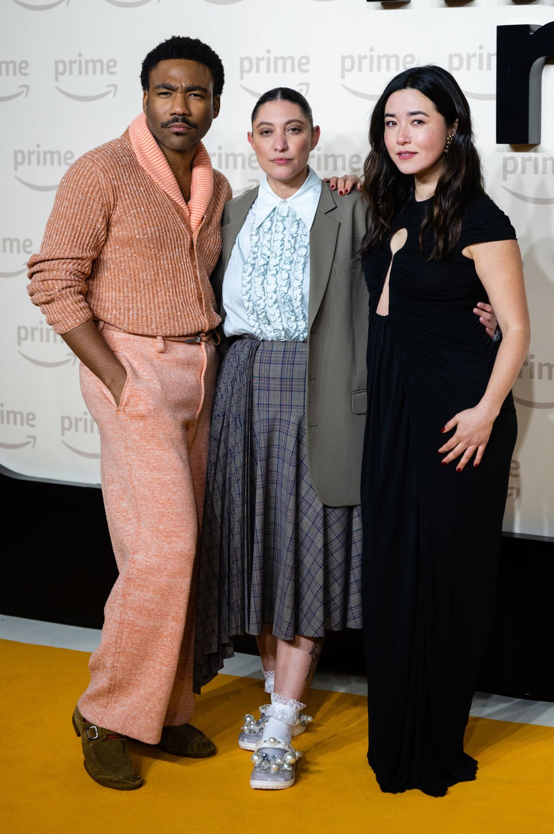 Writer Francesca Sloane (center) attends the UK premiere of "Mr & Mrs Smith" — along with its stars Donald Glover and Maya Erskine — on January 17, 2024 wearing a pair of pearl-embellished Crocs from fashion designer Simone Rocha, as part of a collaboration with the brand.