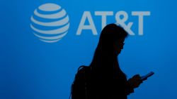 A visitor walks past US multinational telecommunications AT&T logo during the Mobile World Congress (MWC), the telecom industry's biggest annual gathering, in Barcelona on February 26, 2024. The world's biggest mobile phone fair throws open its doors in Barcelona with the sector looking to artificial intelligence to try and reverse declining sales. (Photo by PAU BARRENA / AFP) (Photo by PAU BARRENA/AFP via Getty Images)