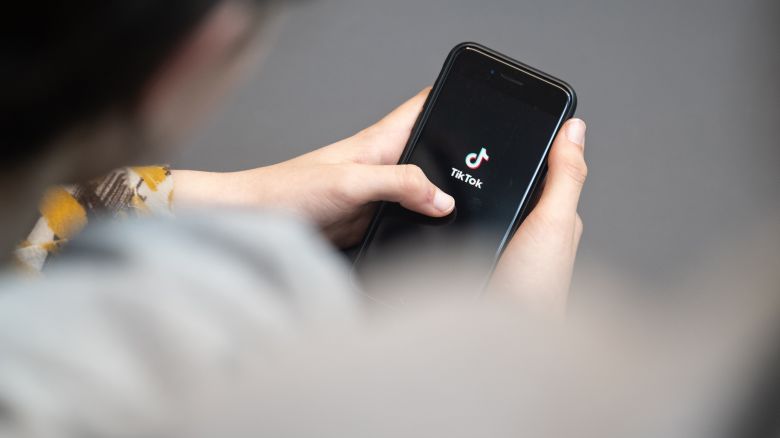 25 April 2024, Berlin: A teenager looks at a smartphone with the TikTok logo displayed. Photo: Hannes P. Albert/ (Photo by Hannes P. Albert/picture alliance via Getty Images)