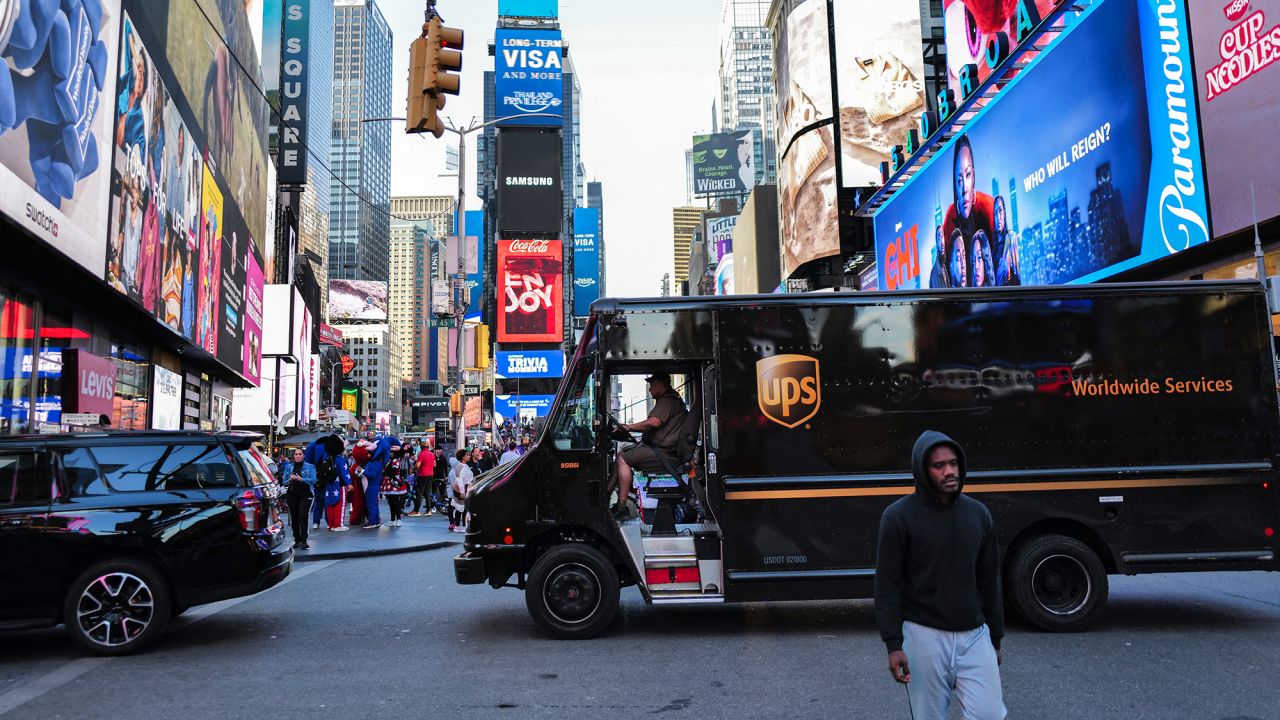A UPS truck driver maneuvers his delivery truck through Times Square in the Manhattan borough of New York on May 1, 2024.