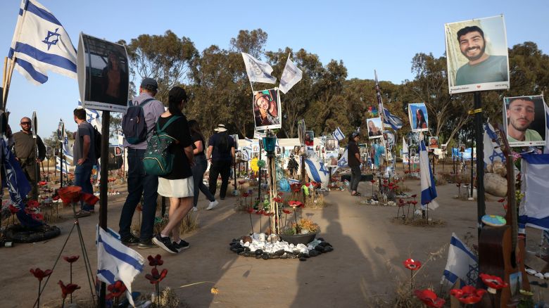 Visitors walk in a memorial bearing portraits of people taken hostage or killed in the Hamas attack on the Supernova music festival on October 7, at the site of the festival near Kibbutz Reim in southern Israel, on May 9, 2024. (Photo by AHMAD GHARABLI / AFP) (Photo by AHMAD GHARABLI/AFP via Getty Images)