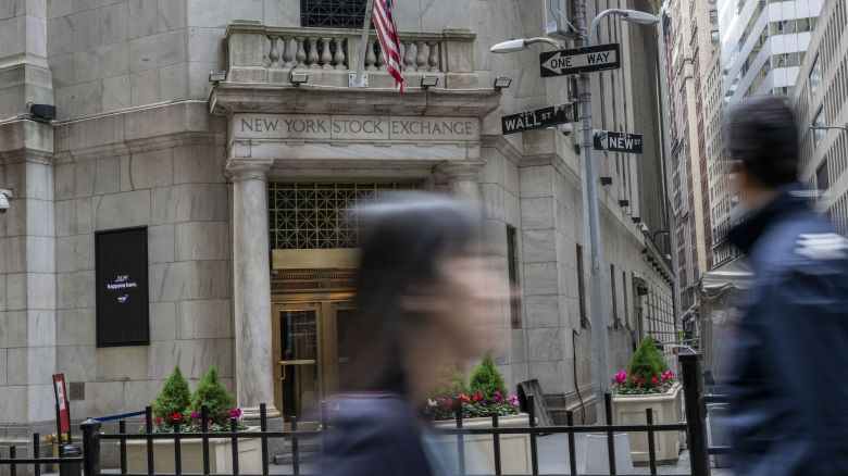 People walk past the New York Stock Exchange (NYSE) at Wall Street on May 17, 2024 in New York City. (Photo by ANGELA WEISS / AFP)