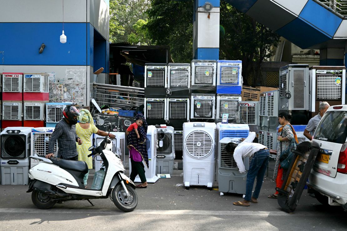 People buy air coolers from a roadside vendor on a hot summer afternoon in New Delhi, India on May 20, 2024, during a brutal heat wave.