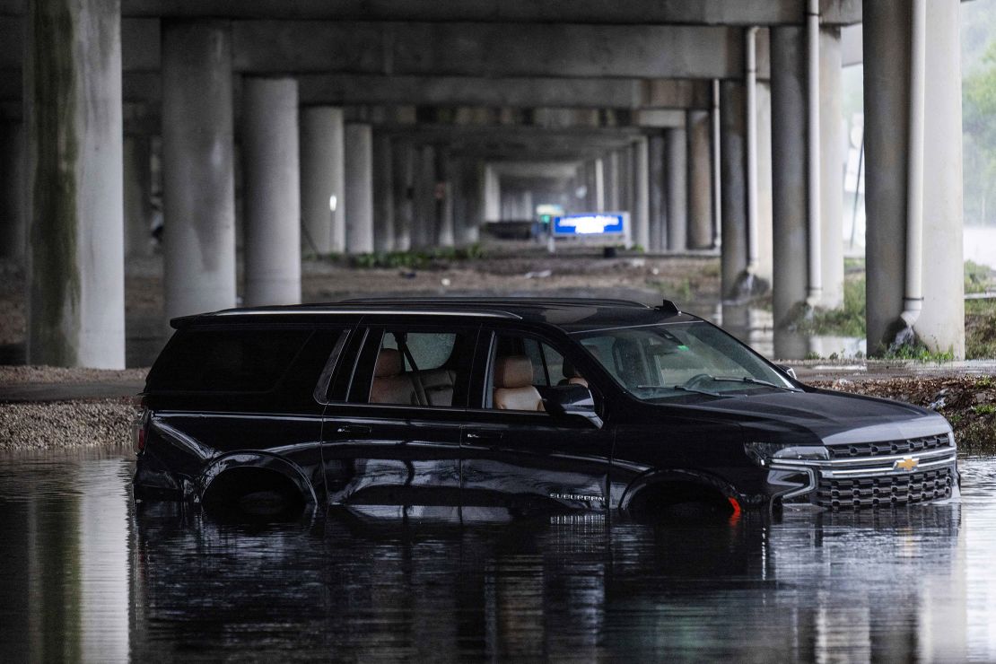 An abandoned car sits submerged in flood waters near the Fort Lauderdale-Hollywood International Airport in Fort Lauderdale, Florida, on Thursday after heavy rainfall hit the area.