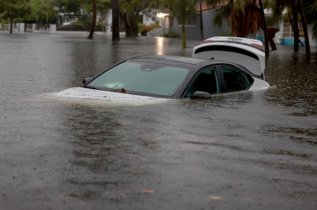 A vehicle sits in floodwaters in Hollywood, Florida on June 12, 2024.