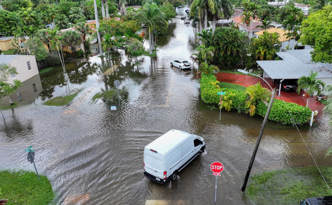 A vehicle is driven through a flooded street in Hallandale Beach, Florida, on Thursday.