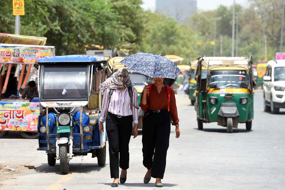 People protect themselves from the summer heat in Gurugram, India on June 18, 2024.