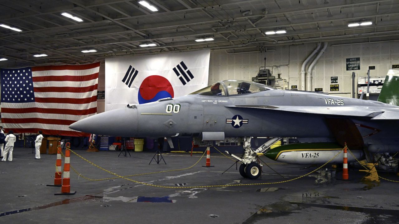 An F-18 fighter aircraft sits in the hanger of the USS Theodore Roosevelt (CVN 71), a nuclear-powered aircraft carrier, anchored in Busan Naval Base in Busan on June 22, 2024. (Photo by SONG Kyung-Seok / POOL / AFP)