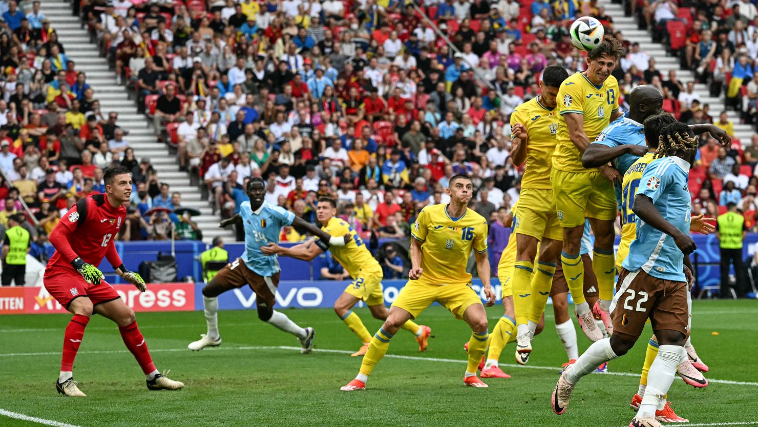 Illia Zabarnyi (No. 13) jumps to head the ball during the Euro 2024 Group E football match between Ukraine and Belgium at the Stuttgart Arena in Stuttgart on June 26, 2024.