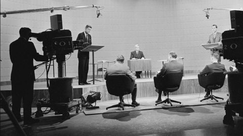 At the first televisied presidential debate, American then-senator and future President John F. Kennedy (1917 - 1963) (on stage at left) speaks while then-Vice President and future President Richard Nixon (1913 - 1994) (right) and journalist and debate chairman Howard K. Smith (1914 - 2002) (on stage, seated in center) listen, Chicago, Illinois, September 25, 1960. (Photo by CBS Photo Archive/Getty Images)   first televisied presidential debate  American senator (and future President) John F. Kennedy (1917 - 1963) American Vice President (and future President) Richard Nixon (1913 - 1994) Chicago, Illinois, September 25, 1960. (Photo by CBS Photo Archive/Getty Images)