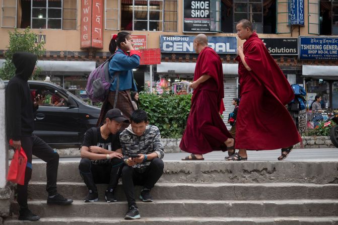 <strong>Life in Bhutan: </strong>This Himalayan country is now opening up to the world. Few images show that contrast better than these Buddhist monks passing some young men using smartphones. Click through the gallery to learn more about this nation.