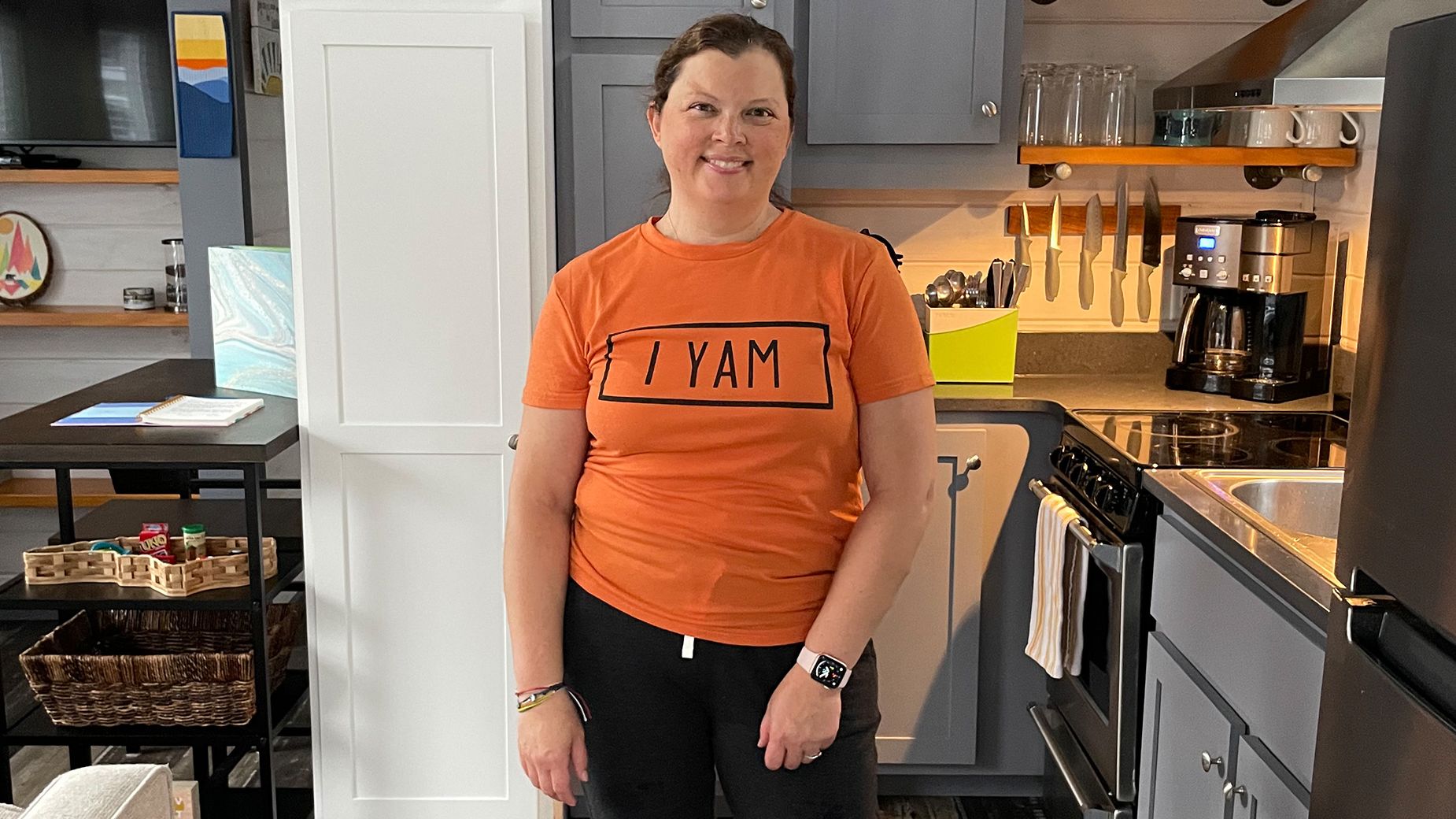 Cherilynne Hill stands in the kitchen of her North Carolina tiny house. She rented several tiny spaces before buying one of her own.