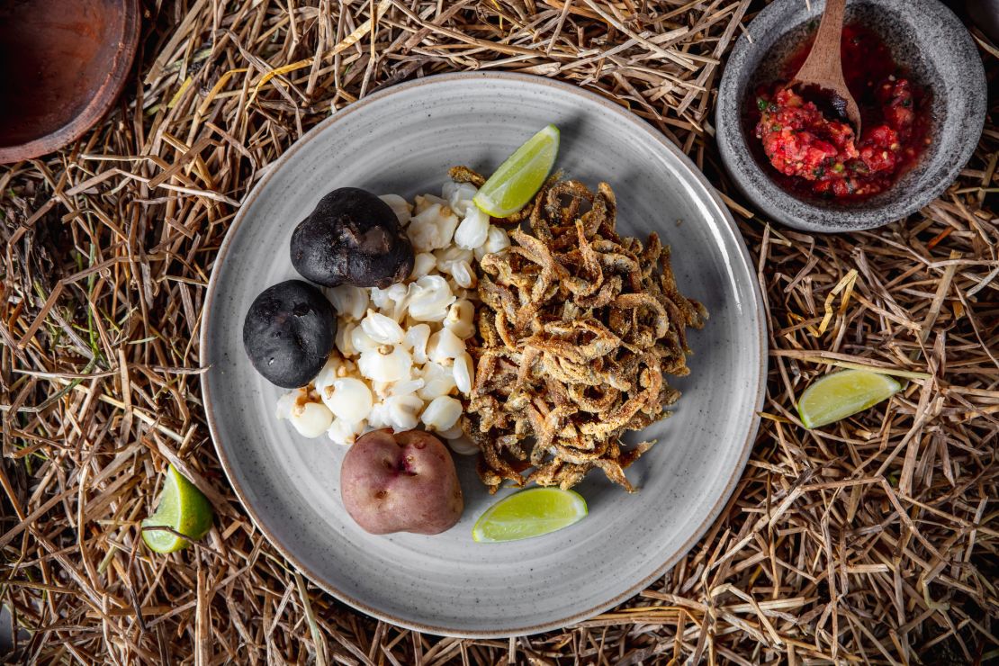 <em>Ispi</em> (small fried fish from Lake Titicaca) is served alongside corn kernels called <em>mote</em>, with <em>chuño</em> (freeze-dried potato) and <em>llajua </em>(Bolivian salsa) at Phayawi in La Paz.