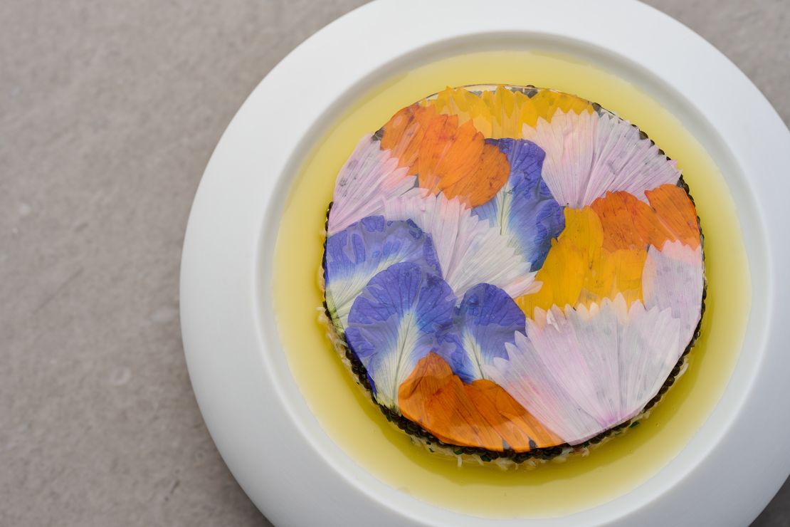 Mauro Colagreco's starter, named Tourteau & Oscietra Caviar, is blanketed with flower petals grown on his restaurant's farm.