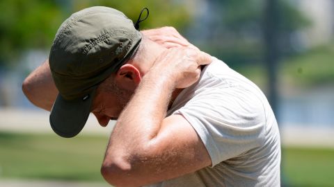 Joel Armor, 46, applies sunscreen to the back of his neck, Sunday, June 16, 2024, at Small Riverfront Park in Cincinnati. The first heat wave of the year has hit with high temperatures continuing into next week.