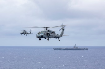 HSM-71, left, and HSC-14 operate from USS Abraham Lincoln (CVN 72) in the Pacific Ocean.