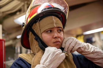 LS3 Talamantez participates in a damage control drill aboard USS Ralph Johnson (DDG 114) in the Sea of Japan.