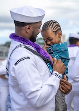 CS1 Randon Booth greets his family after USS Charlotte (SSN 766) returns from deployment at Joint Base Pearl Harbor-Hickam.